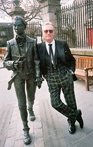 Scott Martin standing beside the statue of the poet, Robert Ferguson 